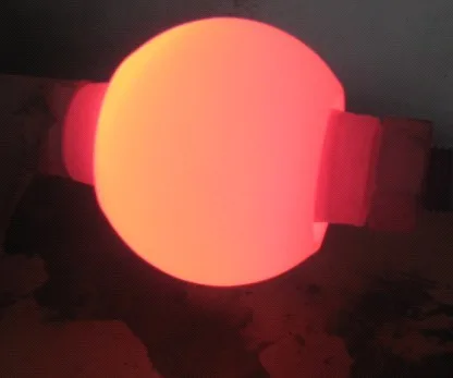 Trunnion valve ball glowing red during the tungsten carbide and Alloy 6 hardfacing process
